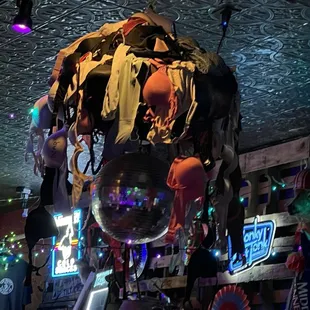 A disco ball with numerous bras