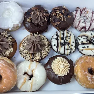L to R: 1st row vanilla coconut, turtle, raspberry zinger. 2nd row somoa, choc caramel choc chip. 3rd row glazed, salted caramel, PB choc
