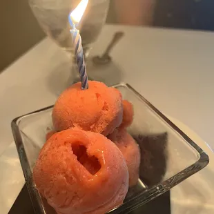 three donuts with a lit candle