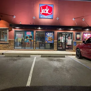 a red car parked in front of a store