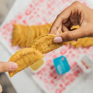 a person holding a piece of food