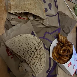 Two chicken fajita pitas, and a large curly fry