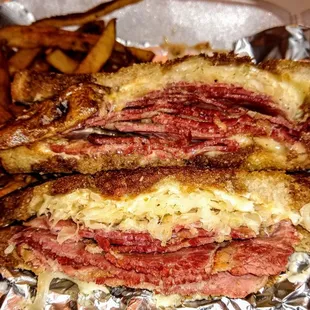 Corned Beef Reuben:  Swiss Cheese, Sauerkraut, Russian Dressing on Marble Rye Bread, served with Hand Cut Fries $12