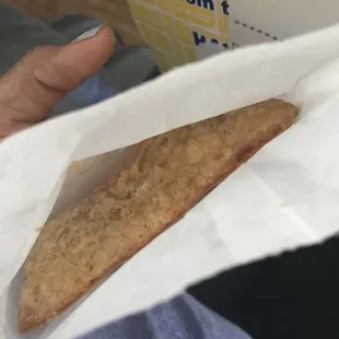 a person holding a piece of food