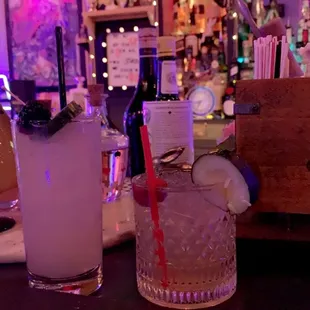 two cocktails on a bar