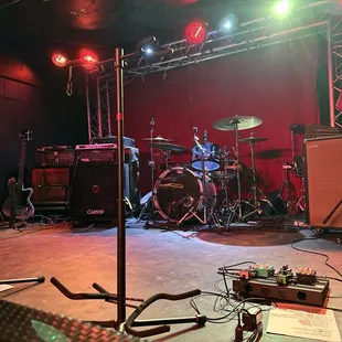 a stage with a guitar, bass, and other musical equipment