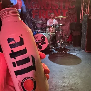 a person holding a bottle of beer