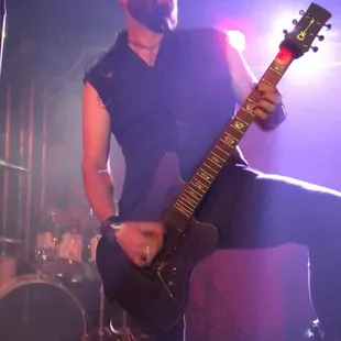 a man playing a guitar on stage