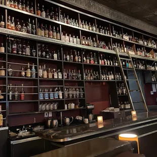 a bar with shelves full of liquor bottles