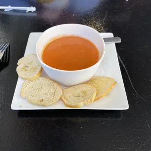 a cup of soup and crackers