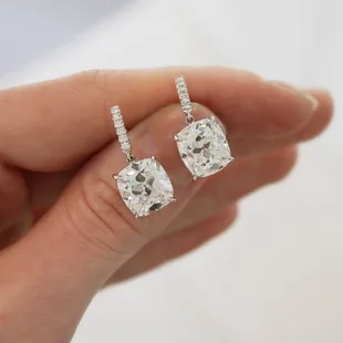 Cushion cut diamond drop earrings.