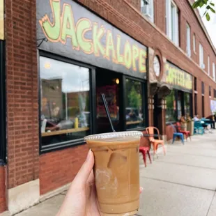 a hand holding a cup of coffee