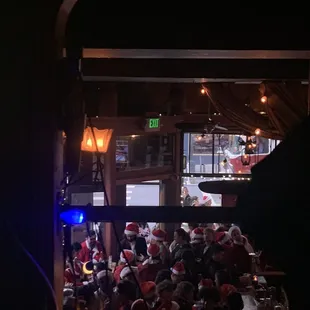 a crowd of people sitting at tables in a restaurant
