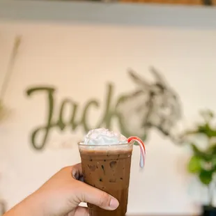 a hand holding a cup of coffee