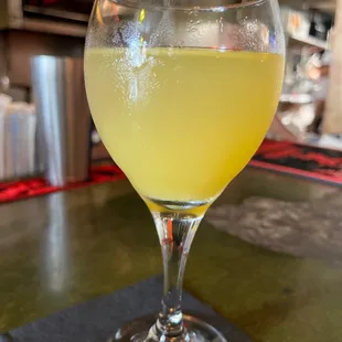 a glass of yellow liquid