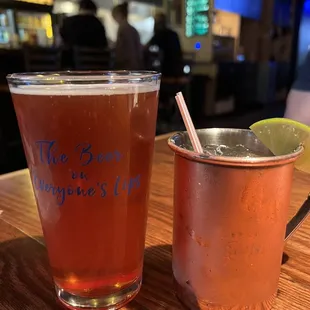a shot of a drink and a mug