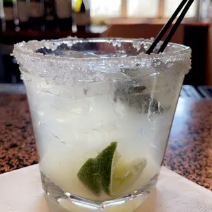 a margarita in a glass on a napkin