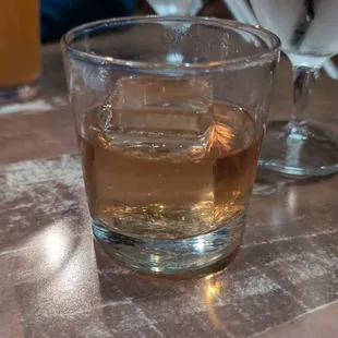 a glass of whiskey on a table
