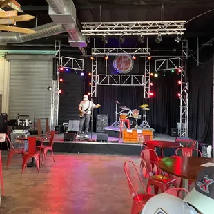 a man playing guitar on stage