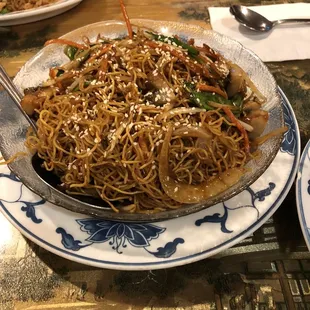 a plate of noodles with meat and vegetables