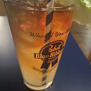 a glass of iced tea with a slice of lime