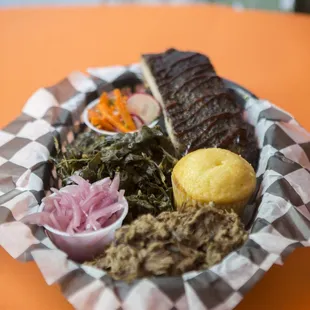 Plate created from the Build Your Own Sampler section -- Pulled Pork, Corn Muffin, Ribs, Carrot &amp; Radish Slaw, Collard Greens, Pickled Onion