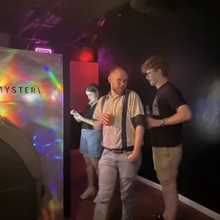 two men standing in front of a tv