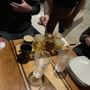 The server helping to explain the beers. Note: They tend to put 2 peoples flights on same tray to conserve table space.