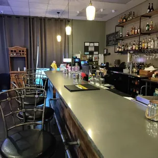 a bar with a counter and chairs