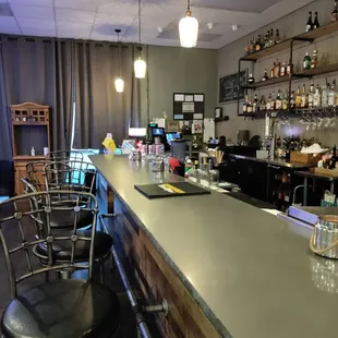a bar with stools and shelves