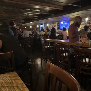 people sitting at tables in a restaurant