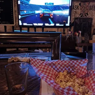 a bowl of popcorn and a glass of water