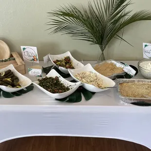 Spread of salads, sarma, hummus, and babaganoush.