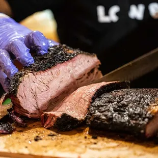 a man cutting up a steak