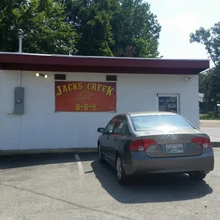 ows a car parked in front of a building