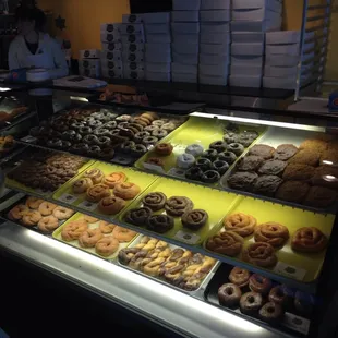 a variety of donuts in a display case