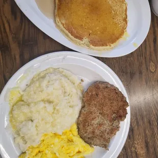 Chicken sausage,  grits, scrambled eggs and pancake. Wings , eggs over medium and potatoes   all freshly made.