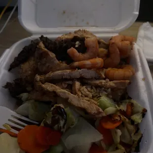 Chicken,steak, and shrimp teriyaki served with vegetables