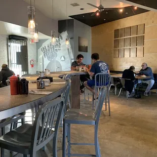 people sitting at tables in a restaurant
