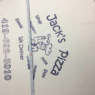 a hand holding a pizza box