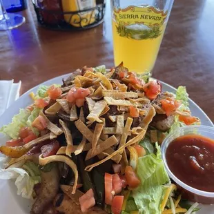 a plate of food and a glass of beer