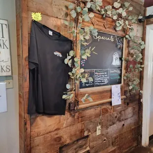 a wooden wall with a chalkboard