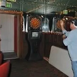 a woman playing a game of darts