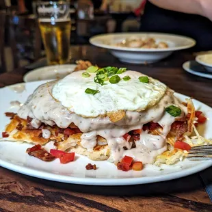 mighty moose, eggs, country fried steak w/gravy over hash browns, bacon and biscuits