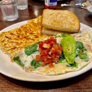 Monterey Omelette - egg white omelette, stuffed with grilled chicken, spinach, pepper jack cheese, and topped with pick de gallo and avocado