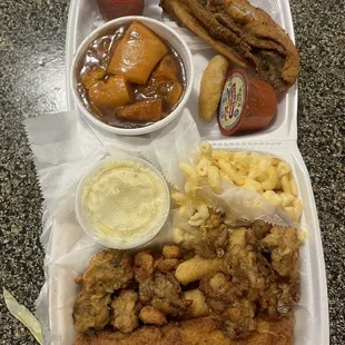 Fried Flounder, oysters, popcorn shrimp, Mac and cheese, yams, potato salad and hush puppies