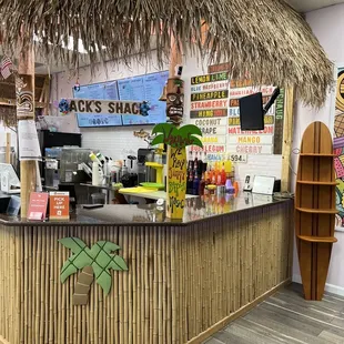 a tiki hut with a surfboard on the counter