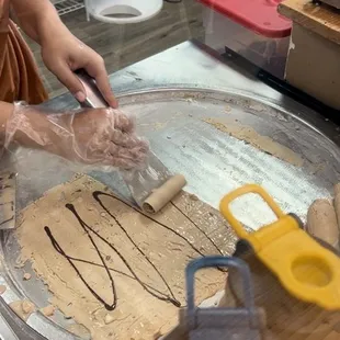 Making the creation- rolling the ice cream