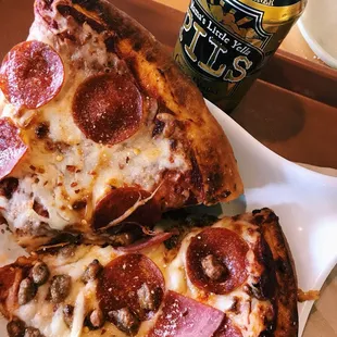 two slices of pepperoni pizza and a can of beer