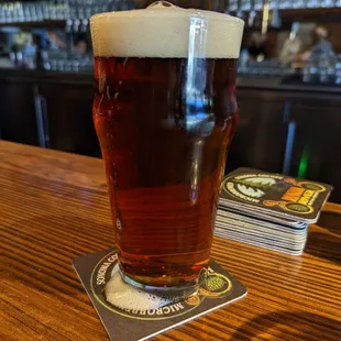 a pint of beer on a coaster